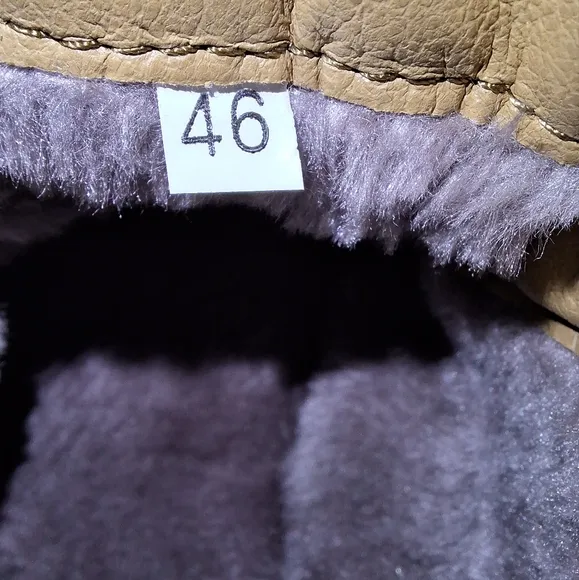 A pair of Fashion Sport moccasin booties with a furry insole.In a men's US 12.