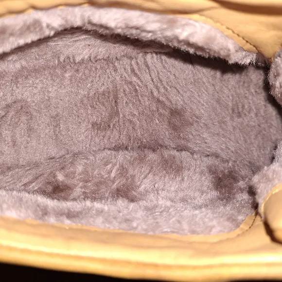 A pair of Fashion Sport moccasin booties with a furry insole.In a men's US 12.