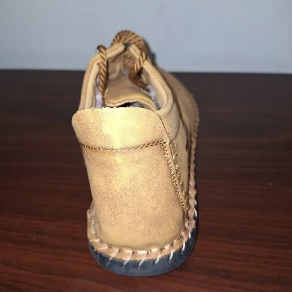 A pair of Fashion Sport moccasin booties with a furry insole.In a men's US 12.