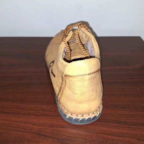 A pair of Fashion Sport moccasin booties with a furry insole.In a men's US 12.