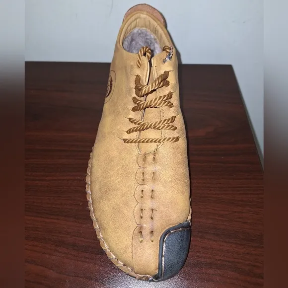 A pair of Fashion Sport moccasin booties with a furry insole.In a men's US 12.