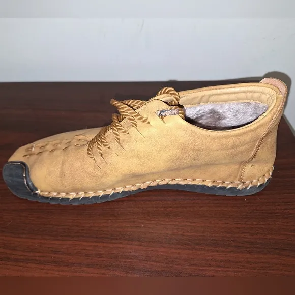 A pair of Fashion Sport moccasin booties with a furry insole.In a men's US 12.