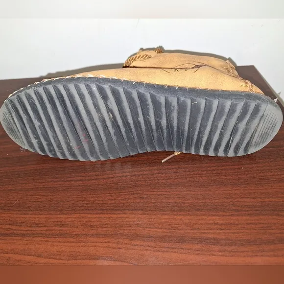 A pair of Fashion Sport moccasin booties with a furry insole.In a men's US 12.
